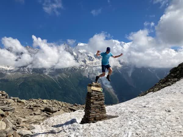 Jumping at a mountain summit in the Alps