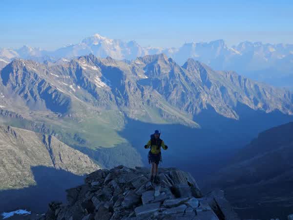Standing on a summit ridge at sunrise